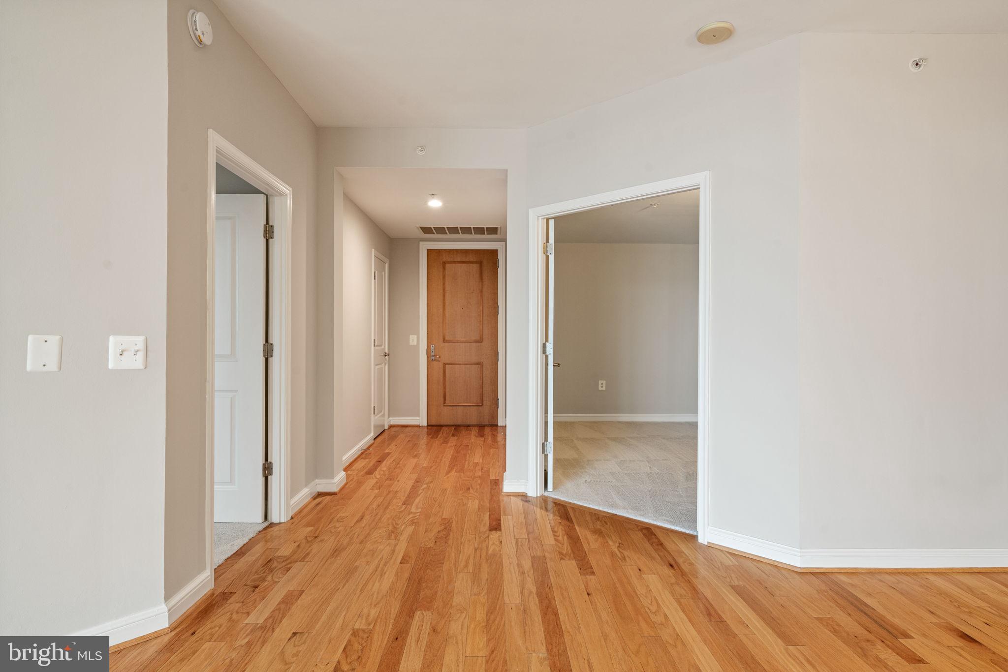 11990 Market Street, Unit 1311 Reston, VA 20190 - Photo 12 of 59 a view of a hallway with wooden floor