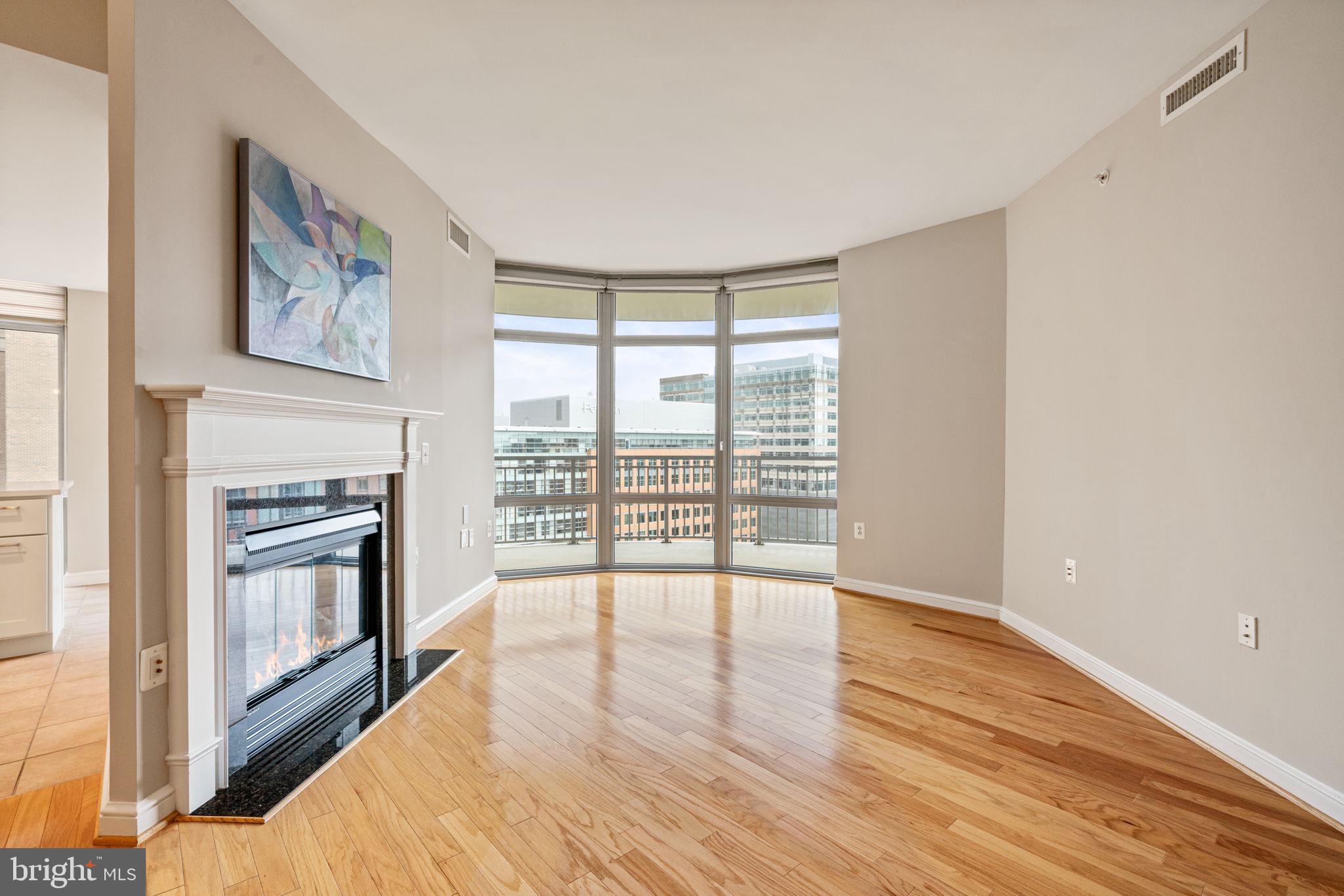 11990 Market Street, Unit 1311 Reston, VA 20190 - Photo 13 of 59 a view of an empty room with wooden floor and a window