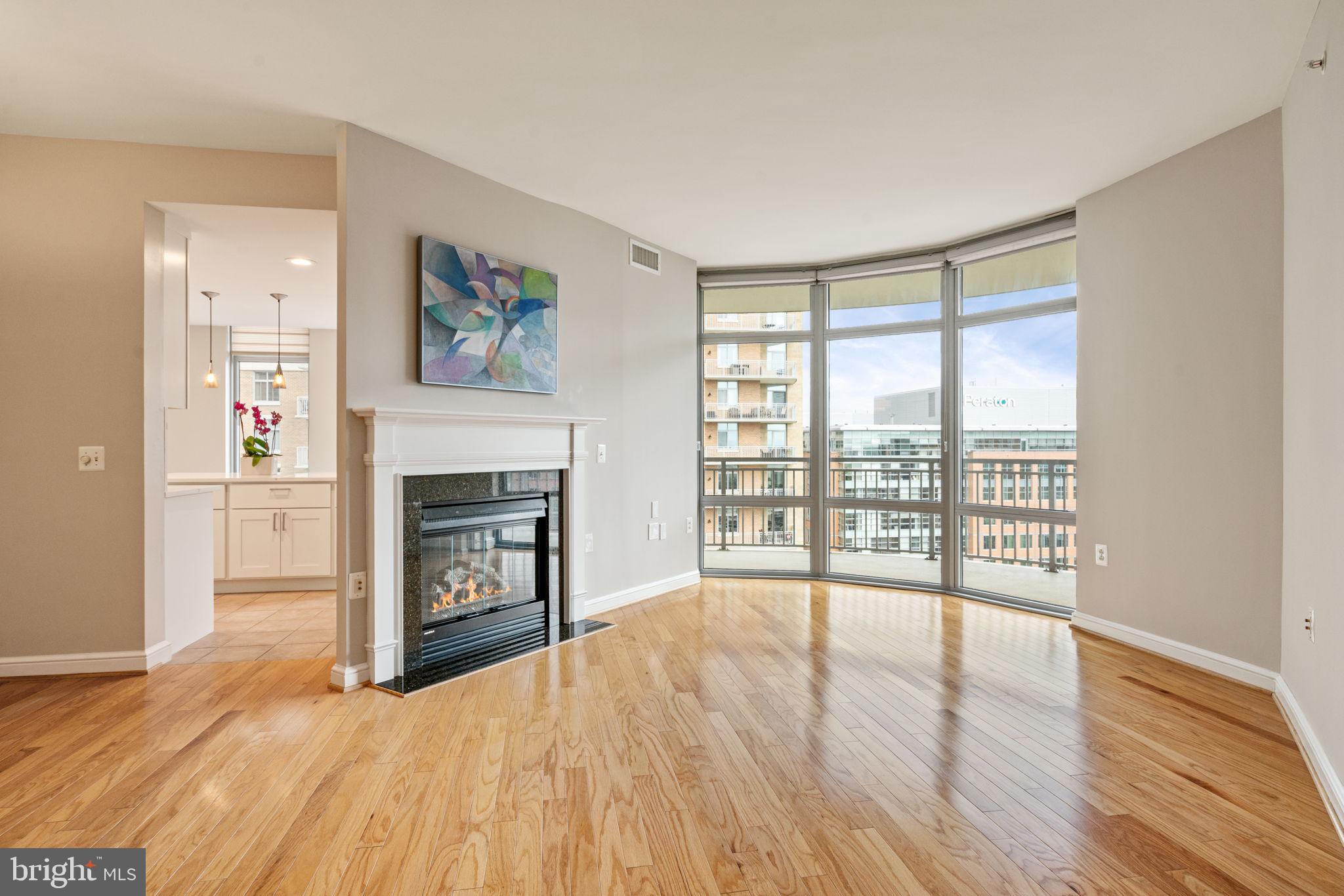 11990 Market Street, Unit 1311 Reston, VA 20190 - Photo 14 of 59 a view of an empty room with a window and a fireplace