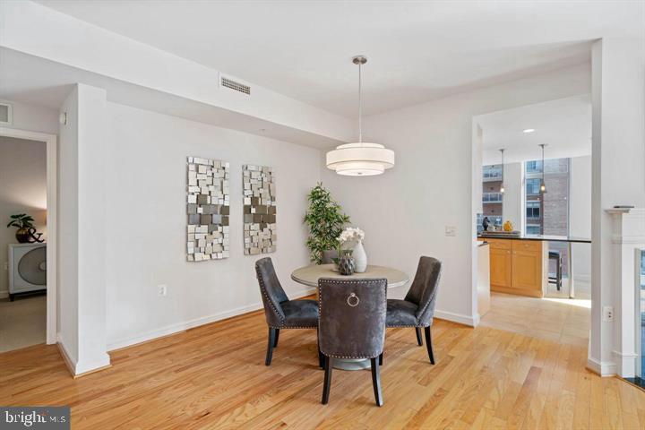 11990 Market Street, Unit 1311 Reston, VA 20190 - Photo 19 of 59 a view of a dining room with furniture and wooden floor