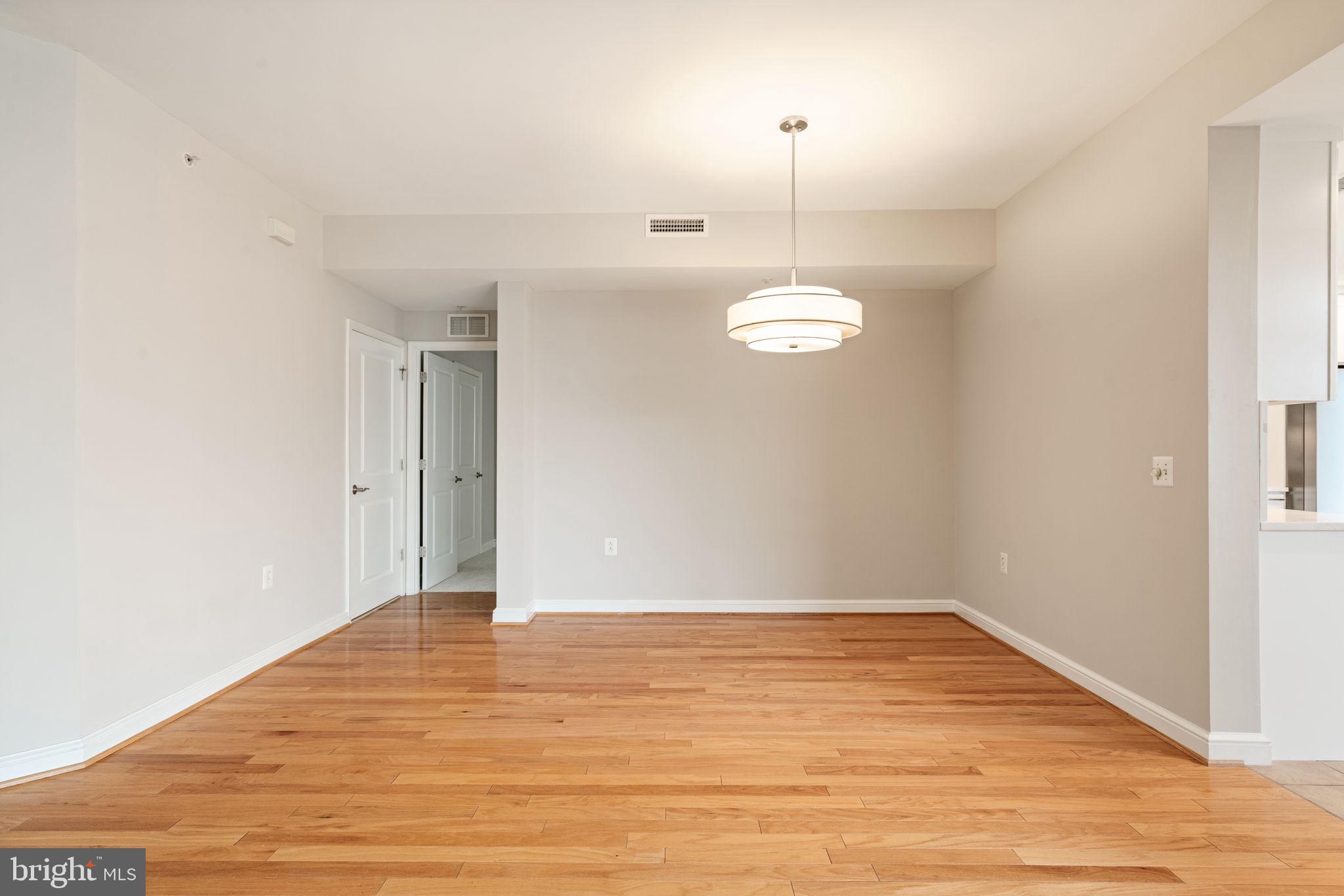 11990 Market Street, Unit 1311 Reston, VA 20190 - Photo 23 of 59 wooden floor in an empty room