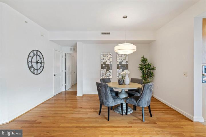 11990 Market Street, Unit 1311 Reston, VA 20190 - Photo 25 of 59 a view of a dining room with furniture window and wooden floor