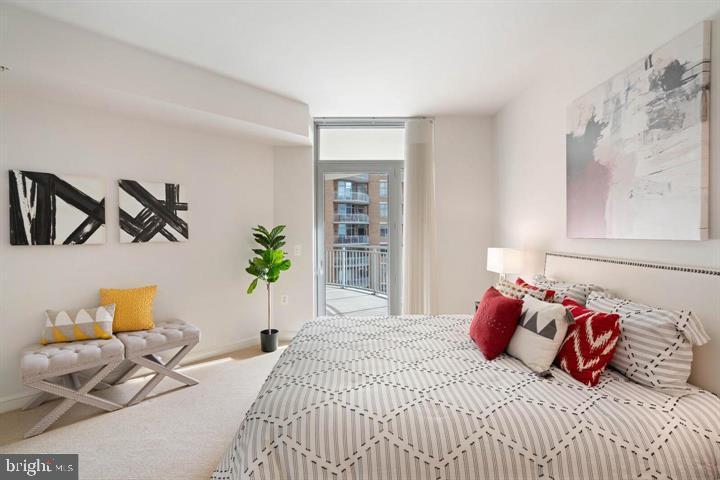 11990 Market Street, Unit 1311 Reston, VA 20190 - Photo 41 of 59 a bedroom with a bed and a couch