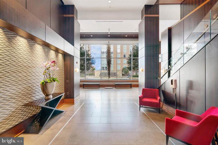 11990 Market Street, Unit 1311 Reston, VA 20190 - Photo 6 of 59 a lobby with furniture and floor to ceiling window