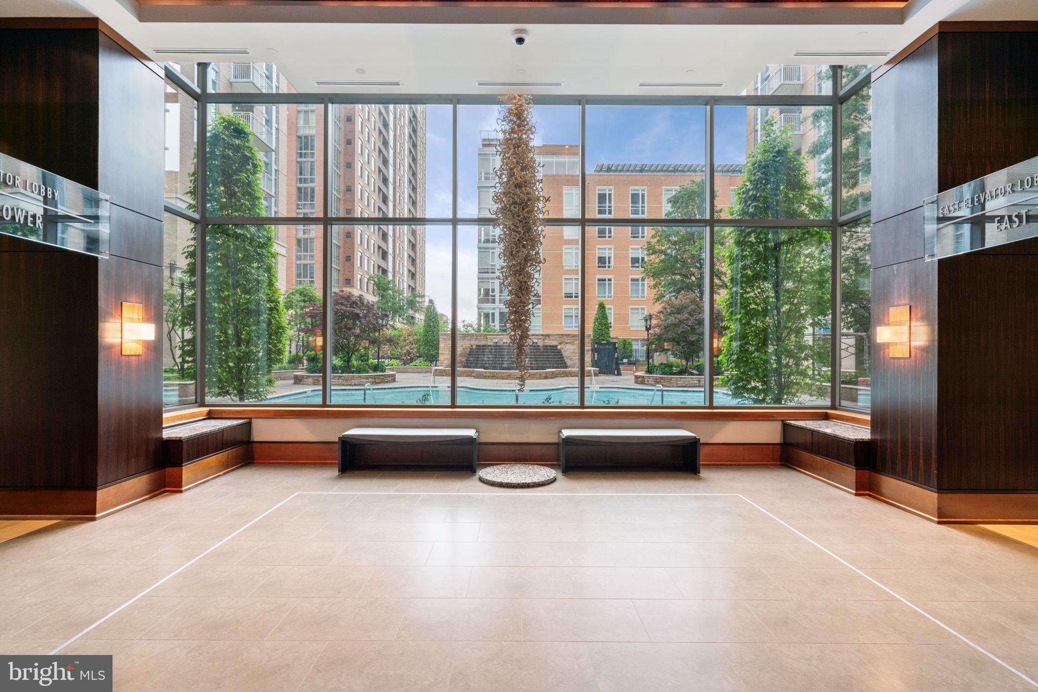 11990 Market Street, Unit 1311 Reston, VA 20190 - Photo 7 of 59 a room with furniture and a floor to ceiling window