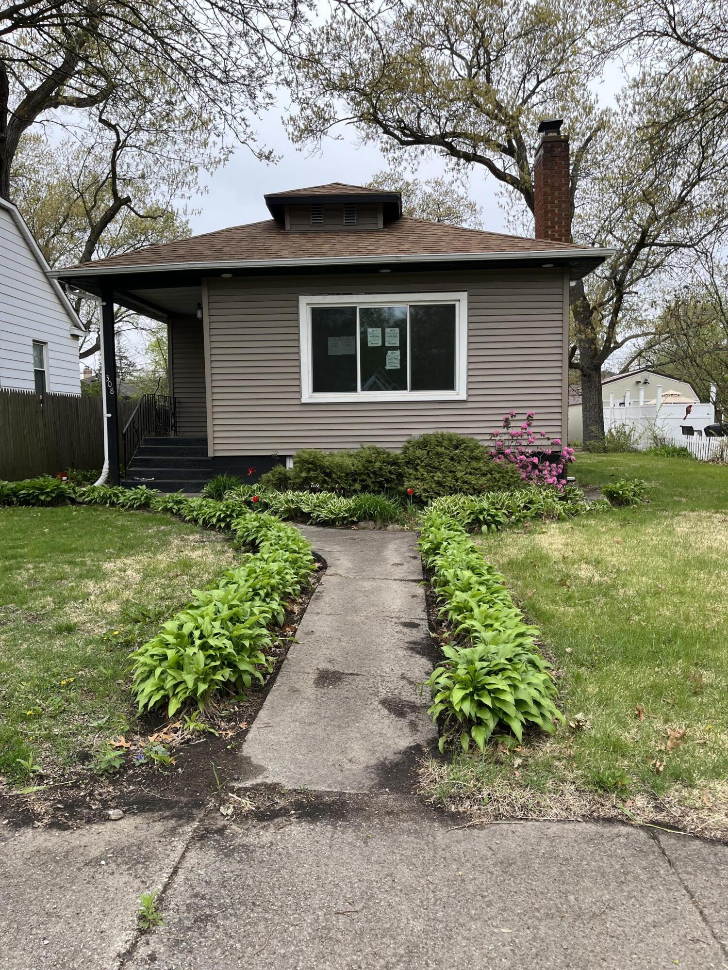 308 South Howard Street Gary, IN 46403 - Photo 1 of 17 a front view of a house with garden