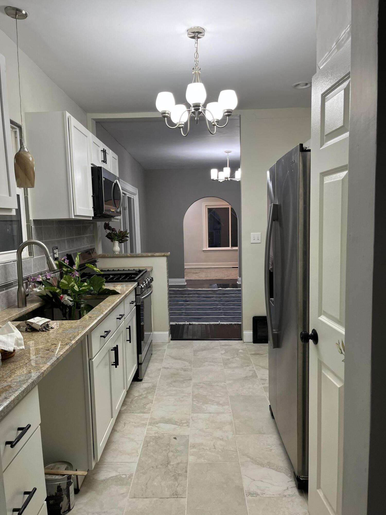 308 South Howard Street Gary, IN 46403 - Photo 12 of 17 a kitchen with stainless steel appliances a refrigerator sink and stove
