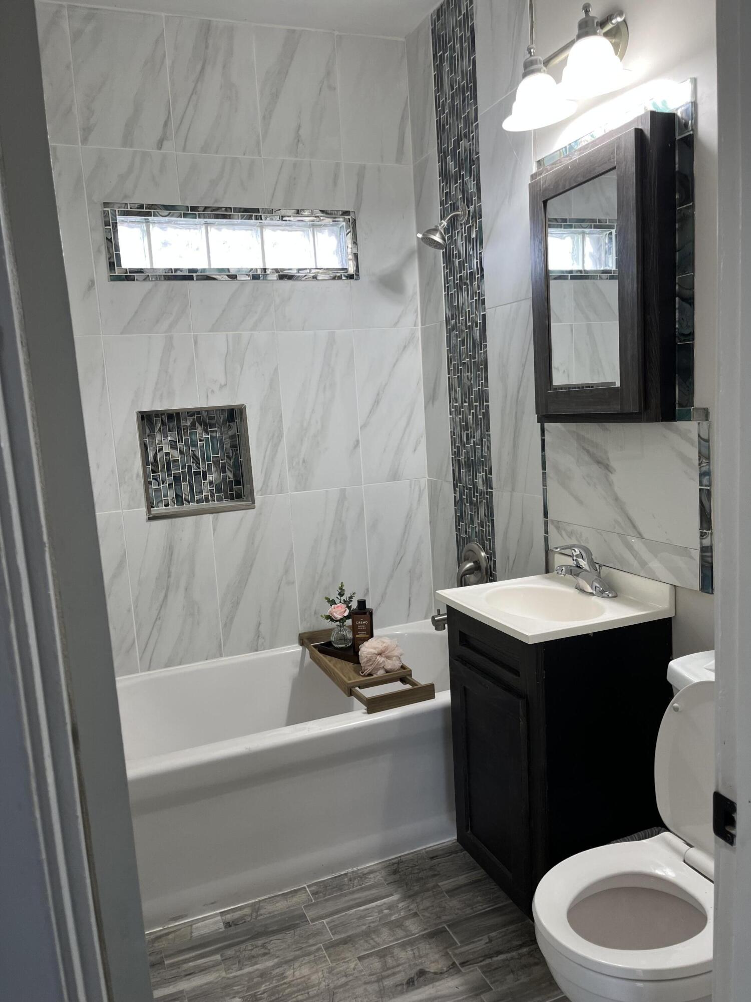 308 South Howard Street Gary, IN 46403 - Photo 13 of 17 a bathroom with a sink a toilet and a mirror
