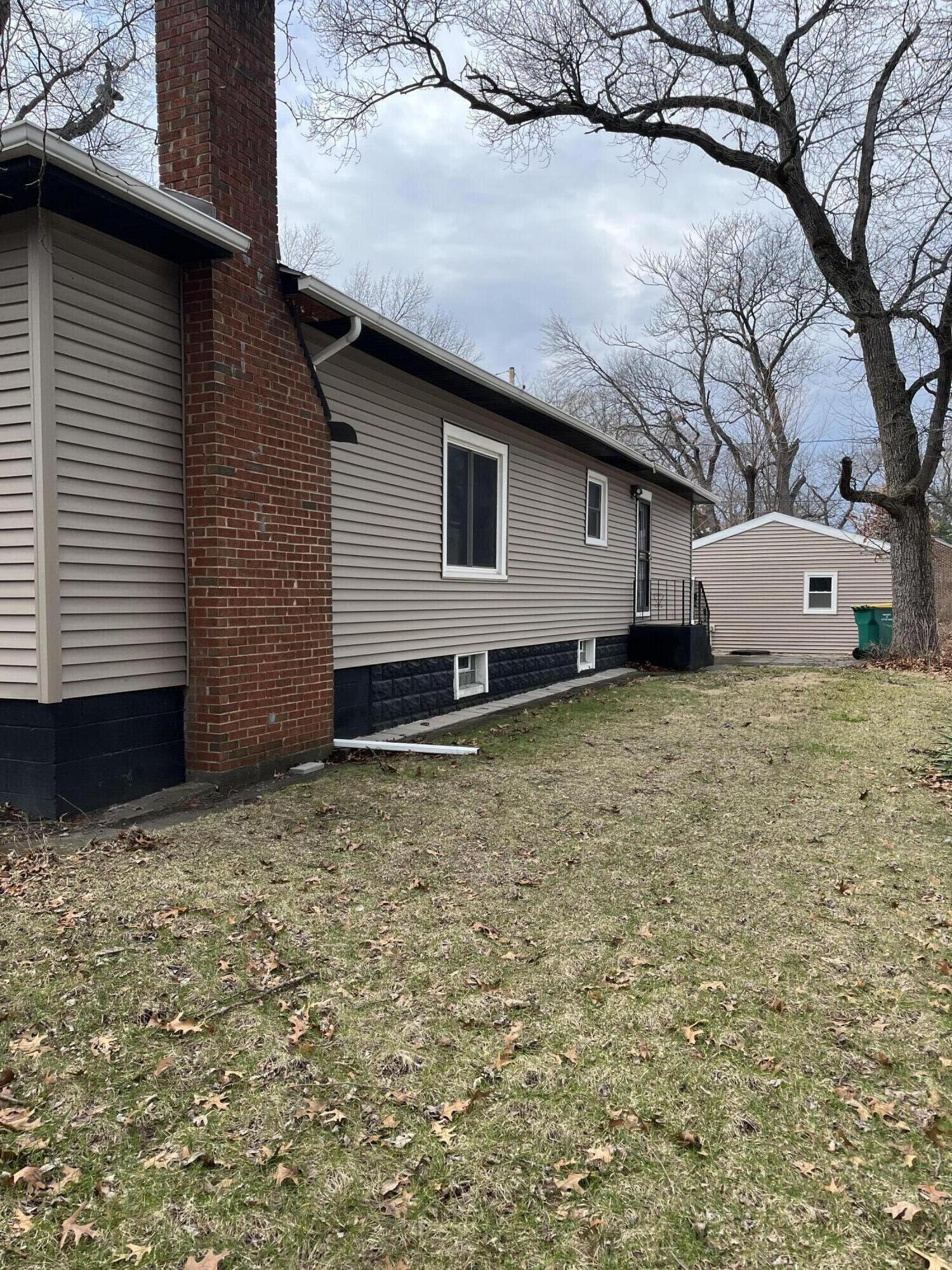 308 South Howard Street Gary, IN 46403 - Photo 2 of 17 a house with yard in front of it