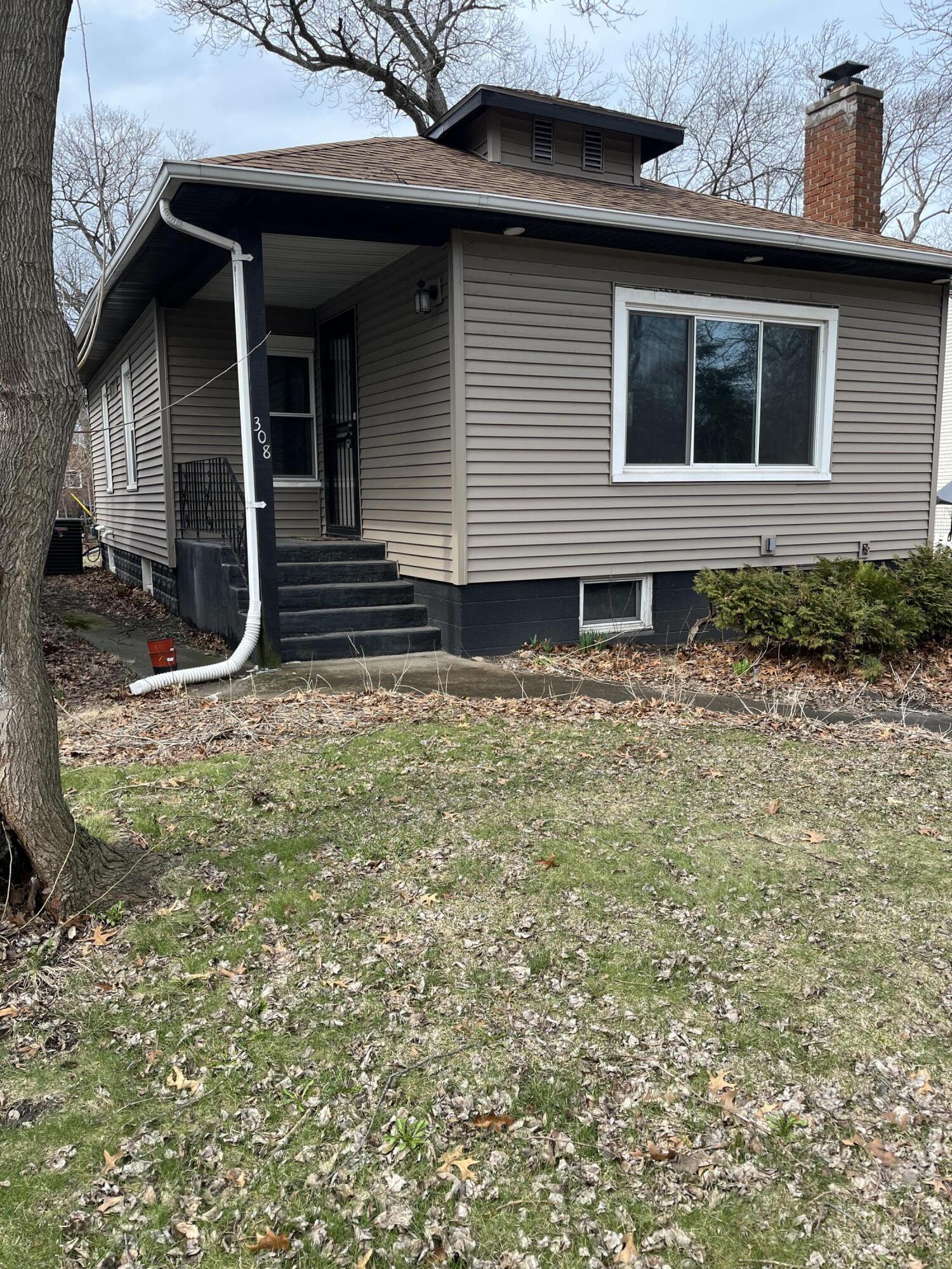 308 South Howard Street Gary, IN 46403 - Photo 6 of 17 a view of a house with a yard