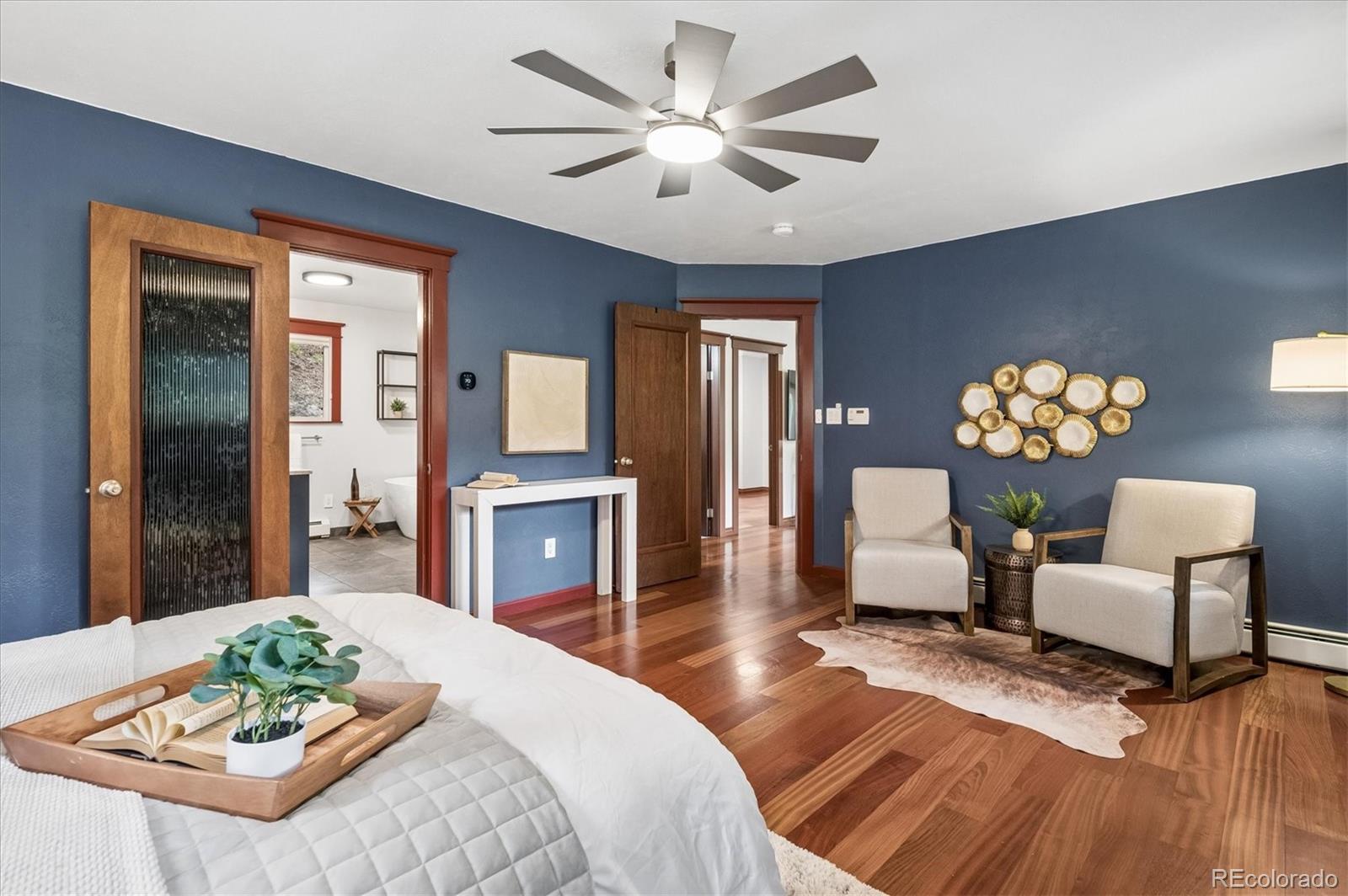 6747 South Brook Forest Road Evergreen, CO 80439 - Photo 21 of 49 a bed room with furniture and a chandelier