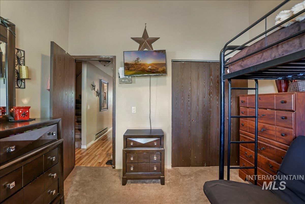 259 Pheasant Road West, Unit 2 Twin Falls, ID 83301 - Photo 15 of 31 Bedroom with light carpet and baseboard heating