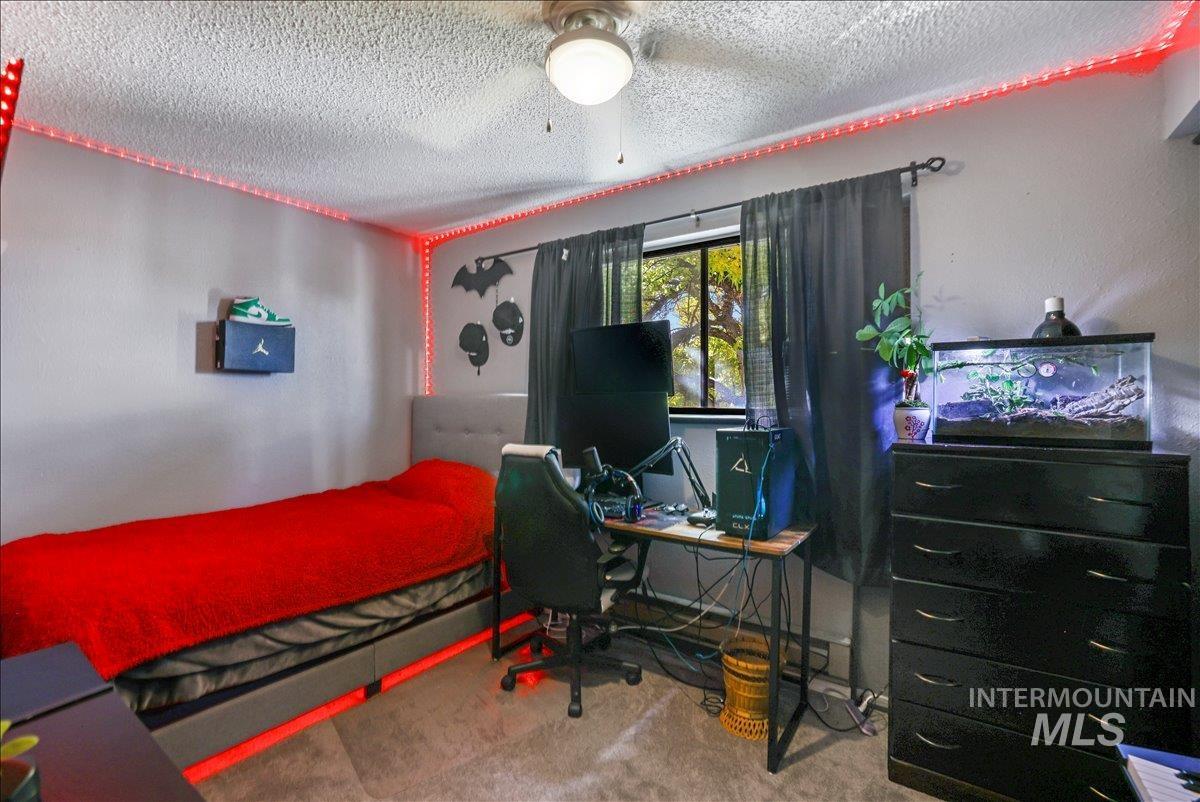 259 Pheasant Road West, Unit 2 Twin Falls, ID 83301 - Photo 18 of 31 Carpeted bedroom with a textured ceiling and a desk