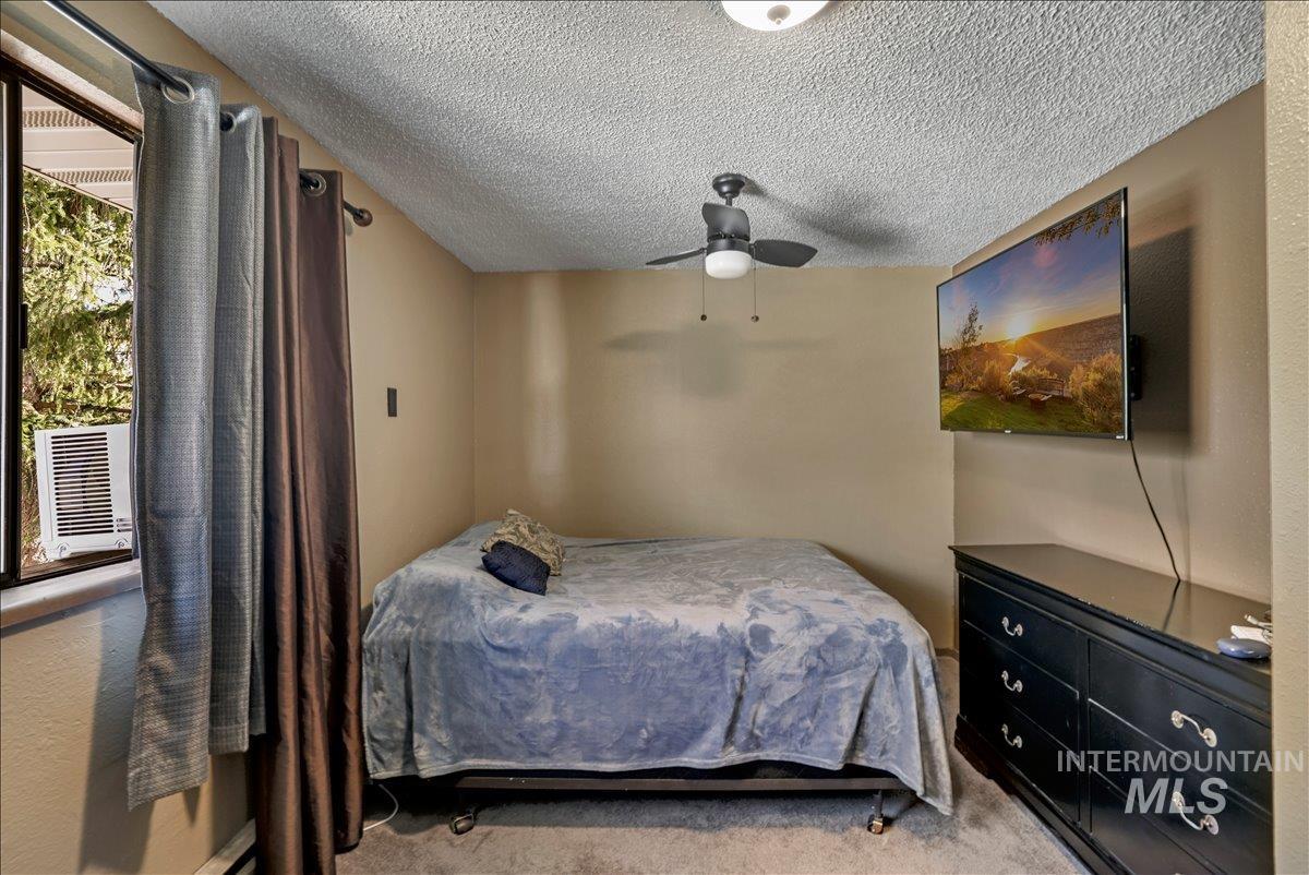259 Pheasant Road West, Unit 2 Twin Falls, ID 83301 - Photo 21 of 31 Carpeted bedroom featuring a textured ceiling and ceiling fan