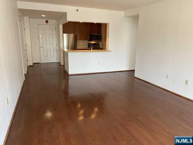 a view of a kitchen with a sink and a refrigerator
