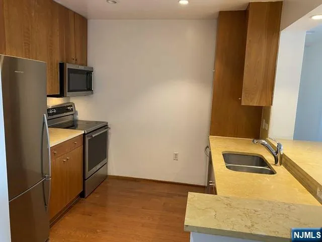 a kitchen with a refrigerator sink and a stove