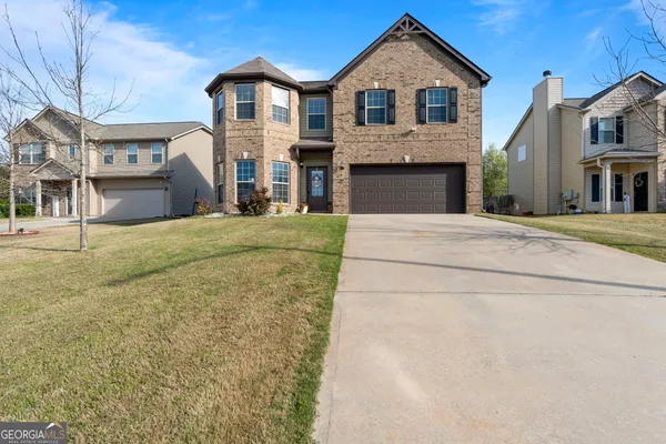 a front view of a house with a yard