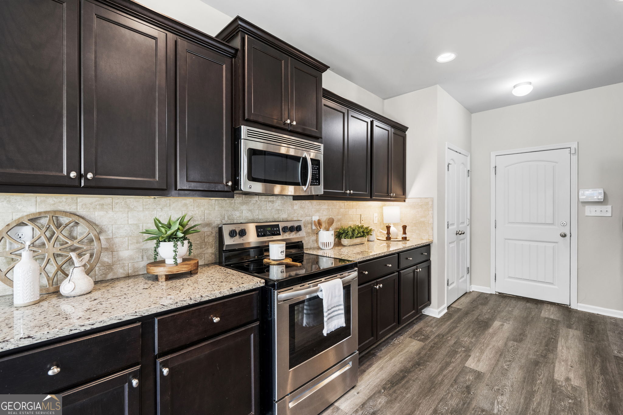 184 Amelia Drive Byron, GA 31008 - Photo 17 of 46 a kitchen with granite countertop wooden cabinets and stainless steel appliances