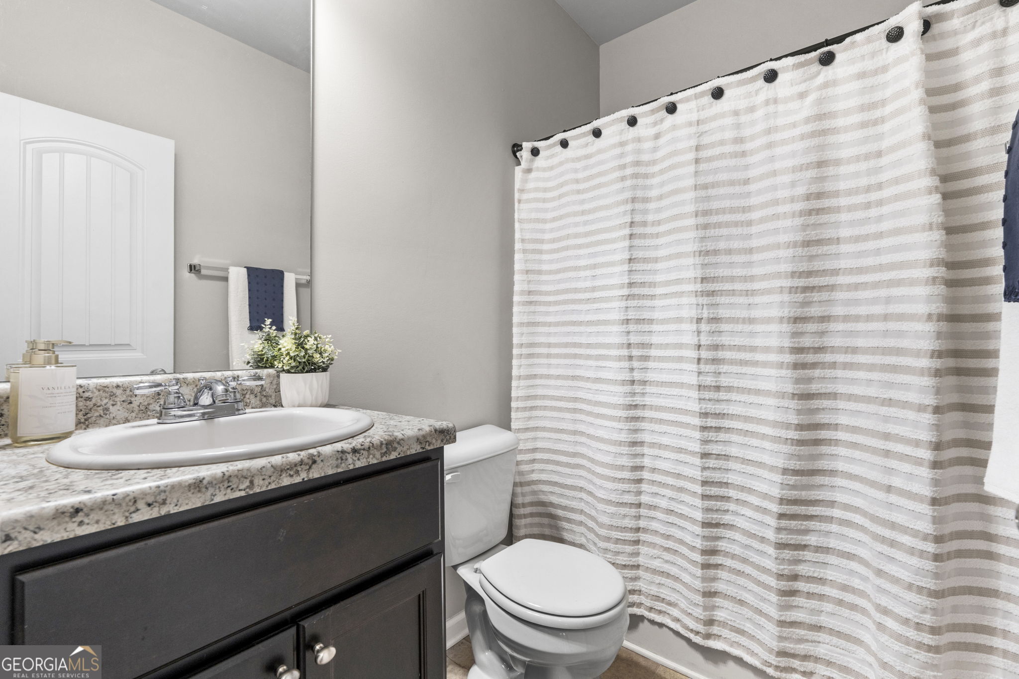 184 Amelia Drive Byron, GA 31008 - Photo 22 of 46 a bathroom with a granite countertop sink toilet and mirror