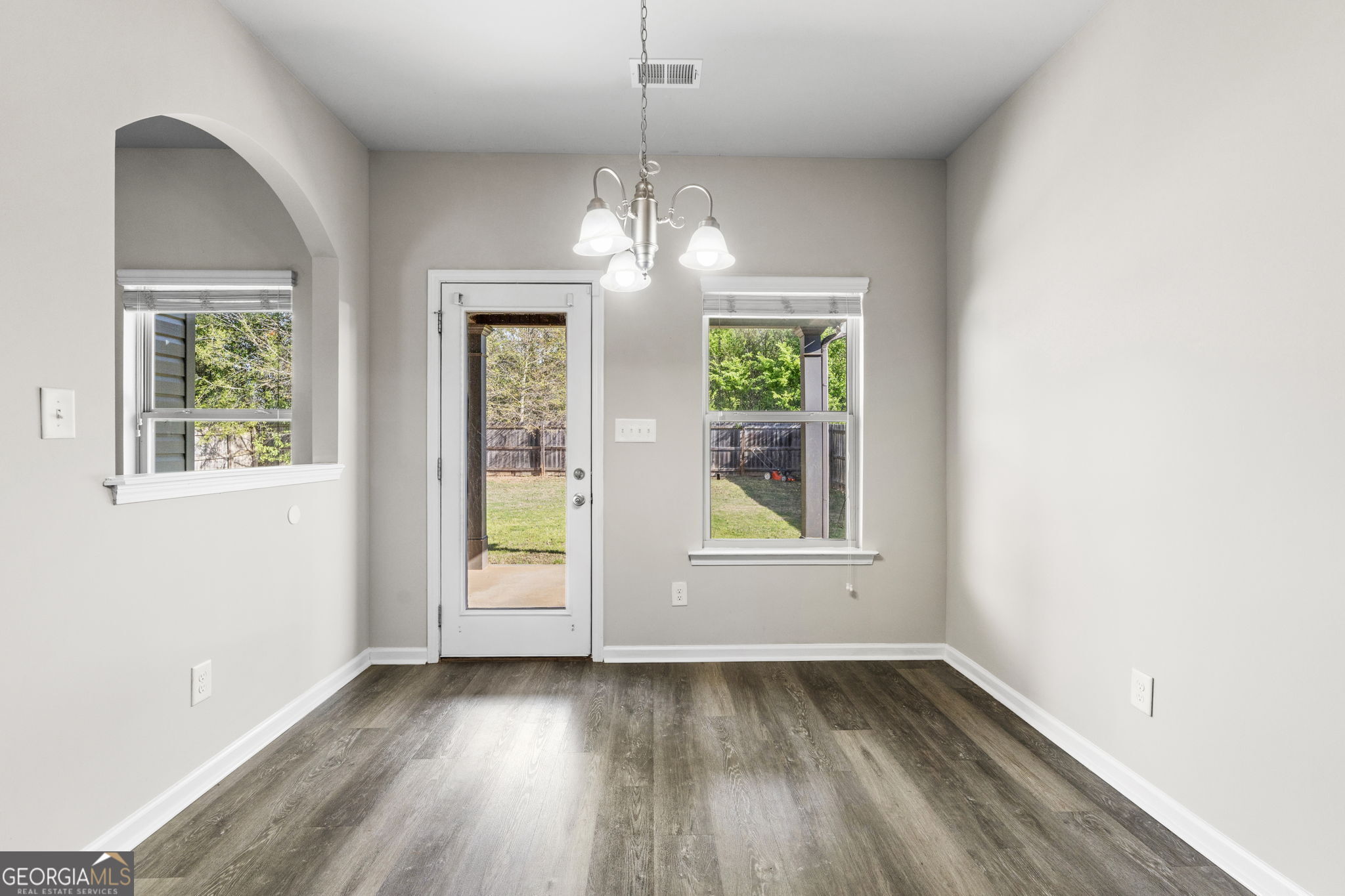 184 Amelia Drive Byron, GA 31008 - Photo 23 of 46 an empty room with wooden floor windows and outdoor view