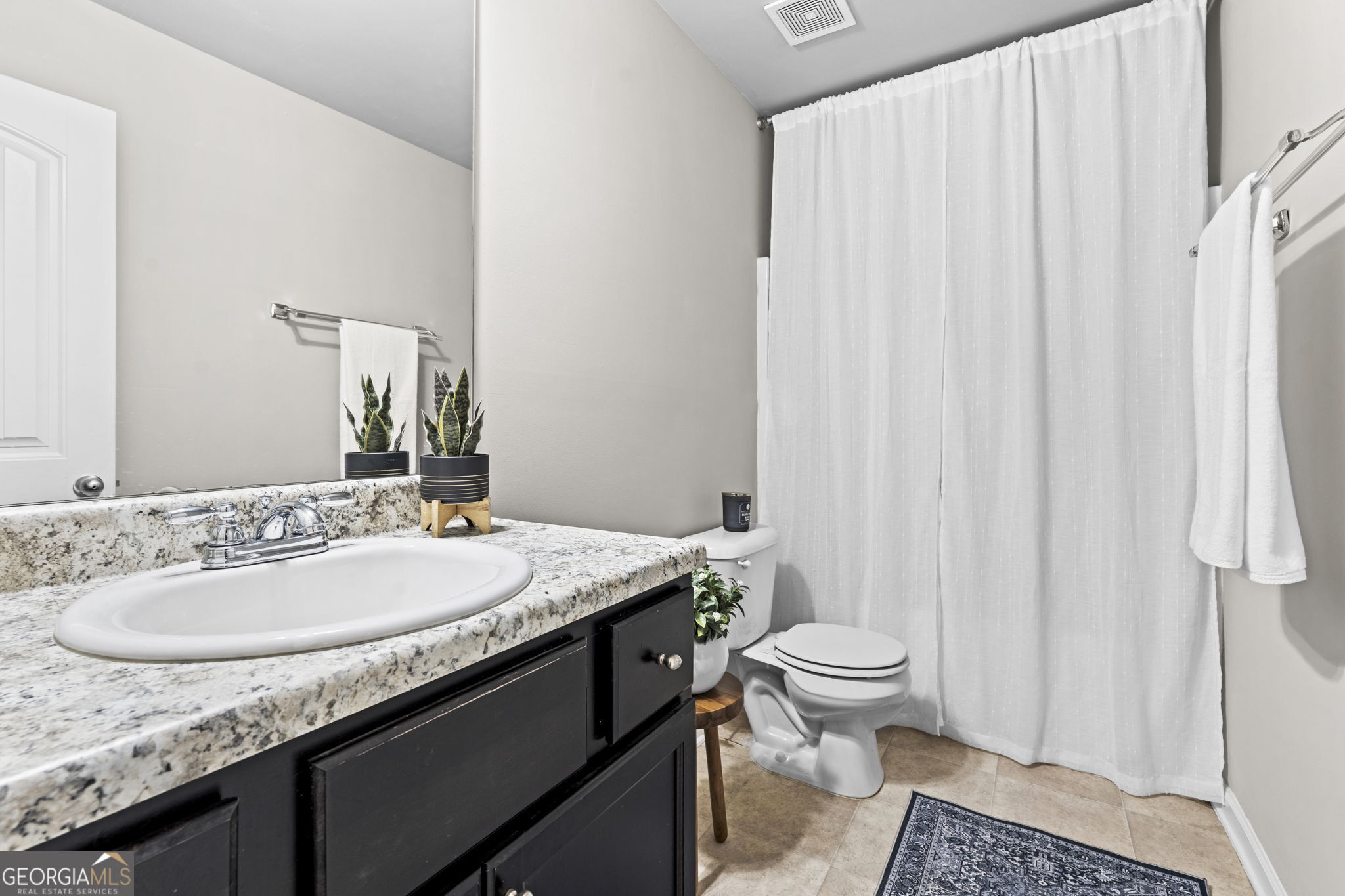 184 Amelia Drive Byron, GA 31008 - Photo 28 of 46 a bathroom with a granite countertop sink and a mirror with toilet