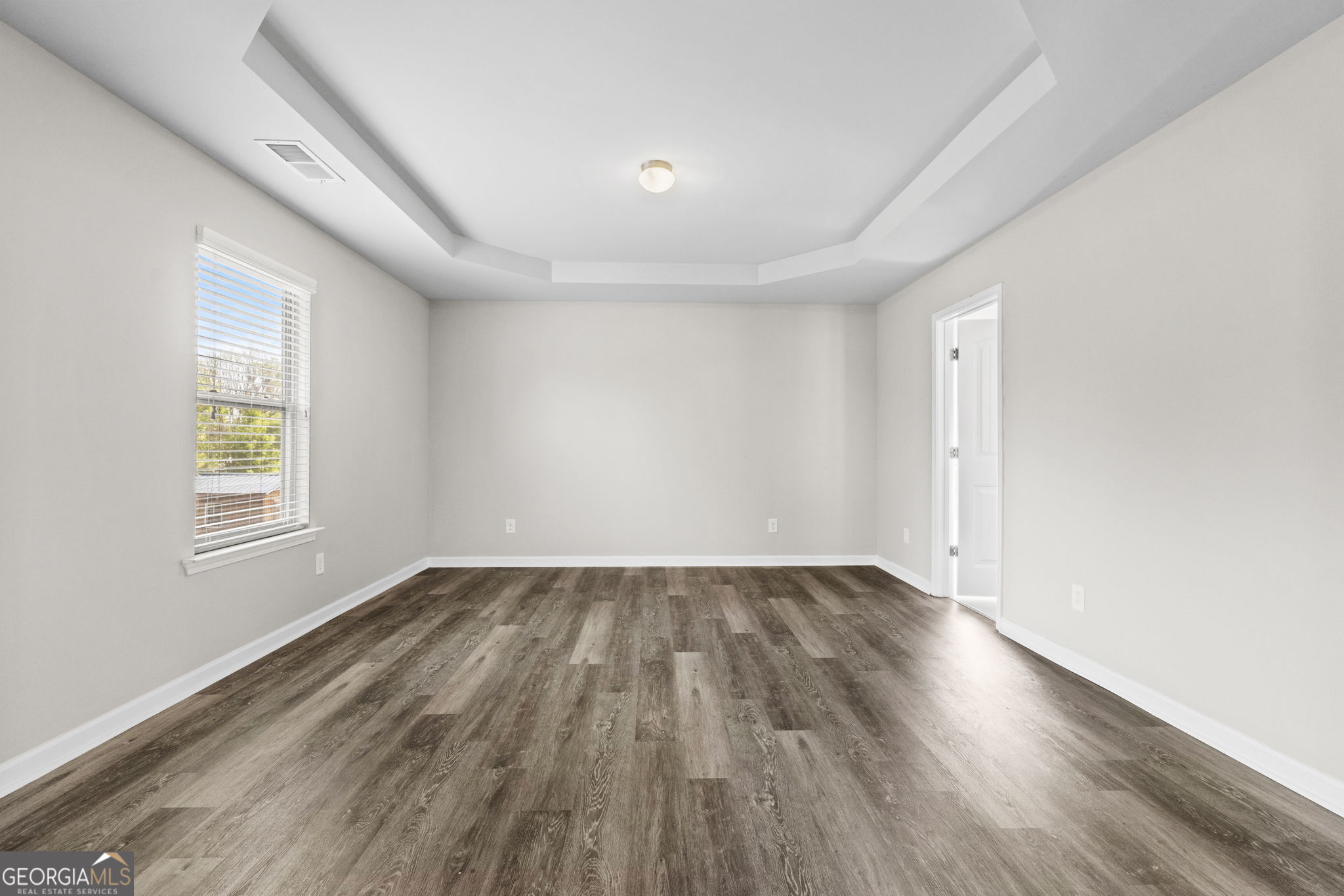 184 Amelia Drive Byron, GA 31008 - Photo 34 of 46 an empty room with wooden floor and windows