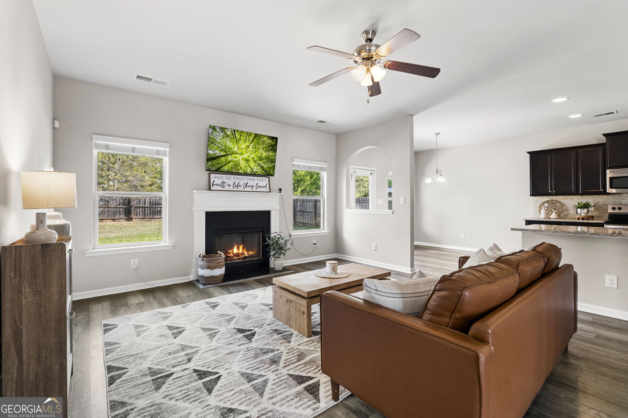 184 Amelia Drive Byron, GA 31008 - Photo 7 of 46 a living room with furniture a fireplace and a flat screen tv