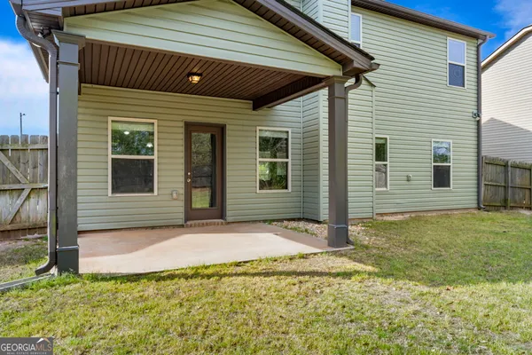 a view of house with backyard