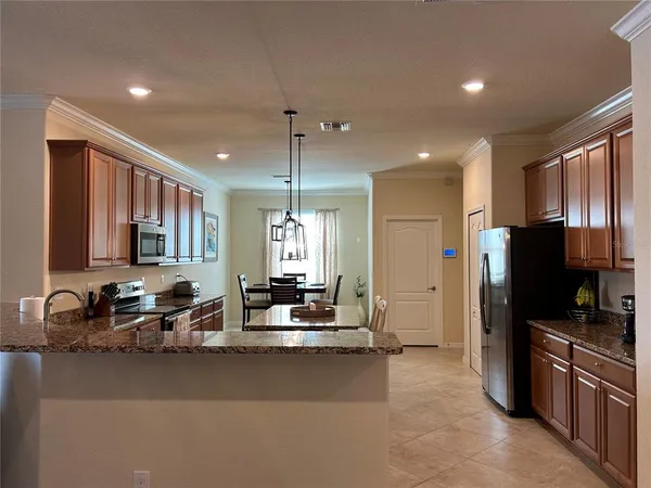 a kitchen with stainless steel appliances a sink stove and refrigerator