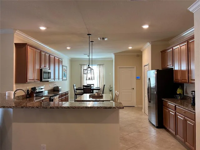 a kitchen with stainless steel appliances a sink stove and refrigerator