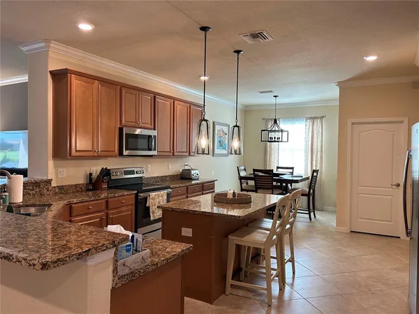 a kitchen with a sink a counter top space appliances and cabinets