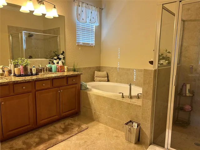 a bathroom with a tub sink and mirror