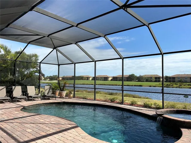 a view of swimming pool with a lounge chairs