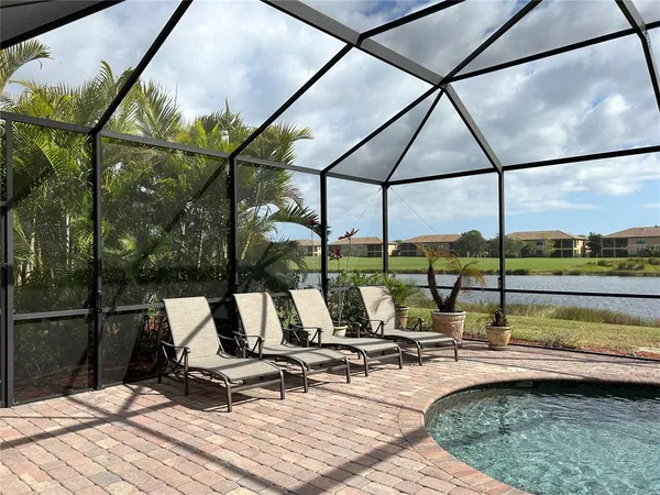a view of swimming pool with seating area and furniture