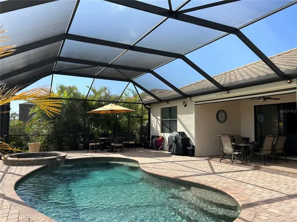 a view of a patio with a table and chairs under an umbrella
