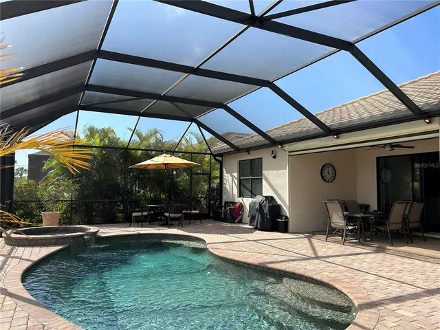 a view of a patio with a table and chairs under an umbrella