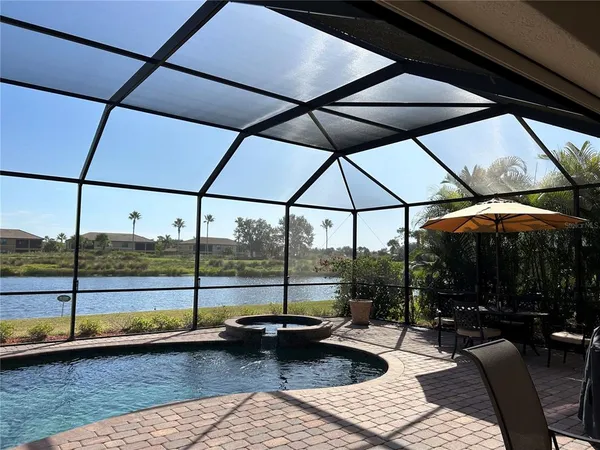 a view of a living room with a floor to ceiling window and an umbrella