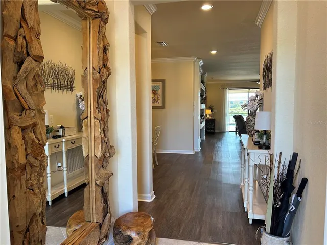 a view of hallway with furniture and wooden floor