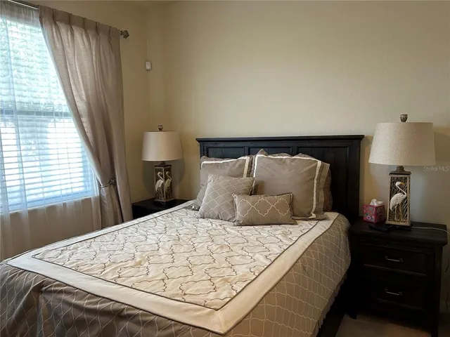 a bedroom with a bed and a window