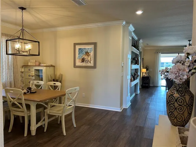 a view of a dining room with furniture wooden floor and a chandelier