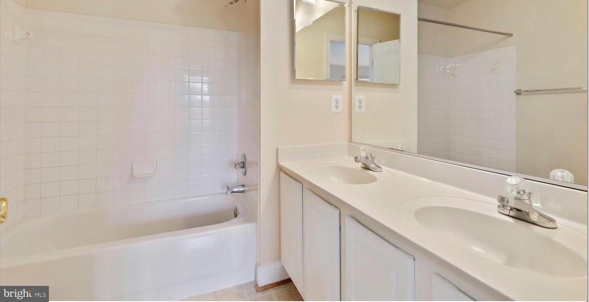 680 Orchard Ridge Drive, Unit 100 Gaithersburg, MD 20878 - Photo 18 of 25 a bathroom with a tub sink and mirror