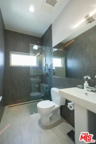 a roof deck with wooden floor and fence