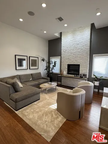a living room with dining room and wooden floor