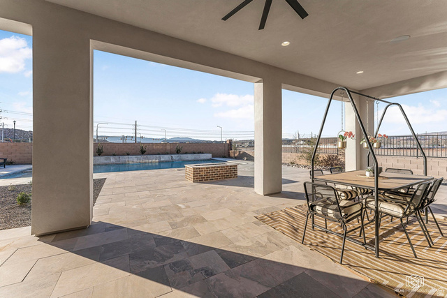 1468 South Red Cliffs Temple Lane St. George, UT 84790 - Photo 52 of 64 Fenced backyard featuring a patio, outdoor dining area, and a ceiling fan
