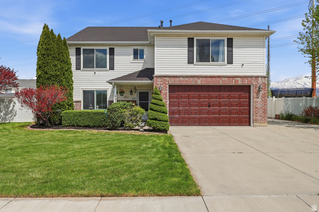 1652 West 800 South Lehi, UT 84043 - Photo 1 of 27 Traditional-style house featuring brick siding, driveway, and an attached garage