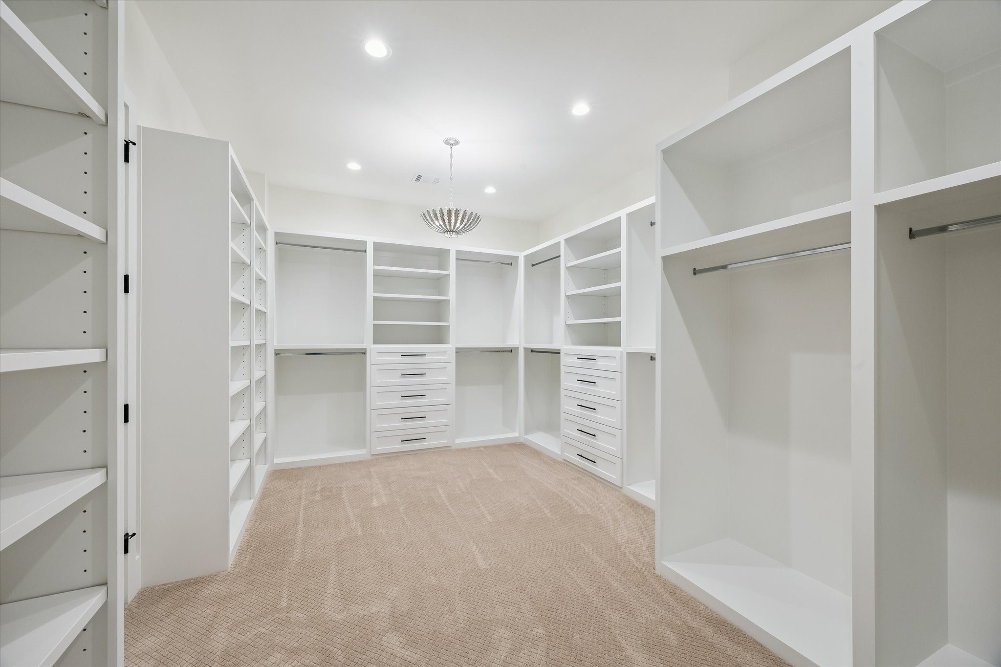65 Shadow Creek Ridge Drive Spring, TX 77389 - Photo 21 of 41 Boutique-style walk-in closet with custom built-ins, drawers, and bright recessed lighting throughout.