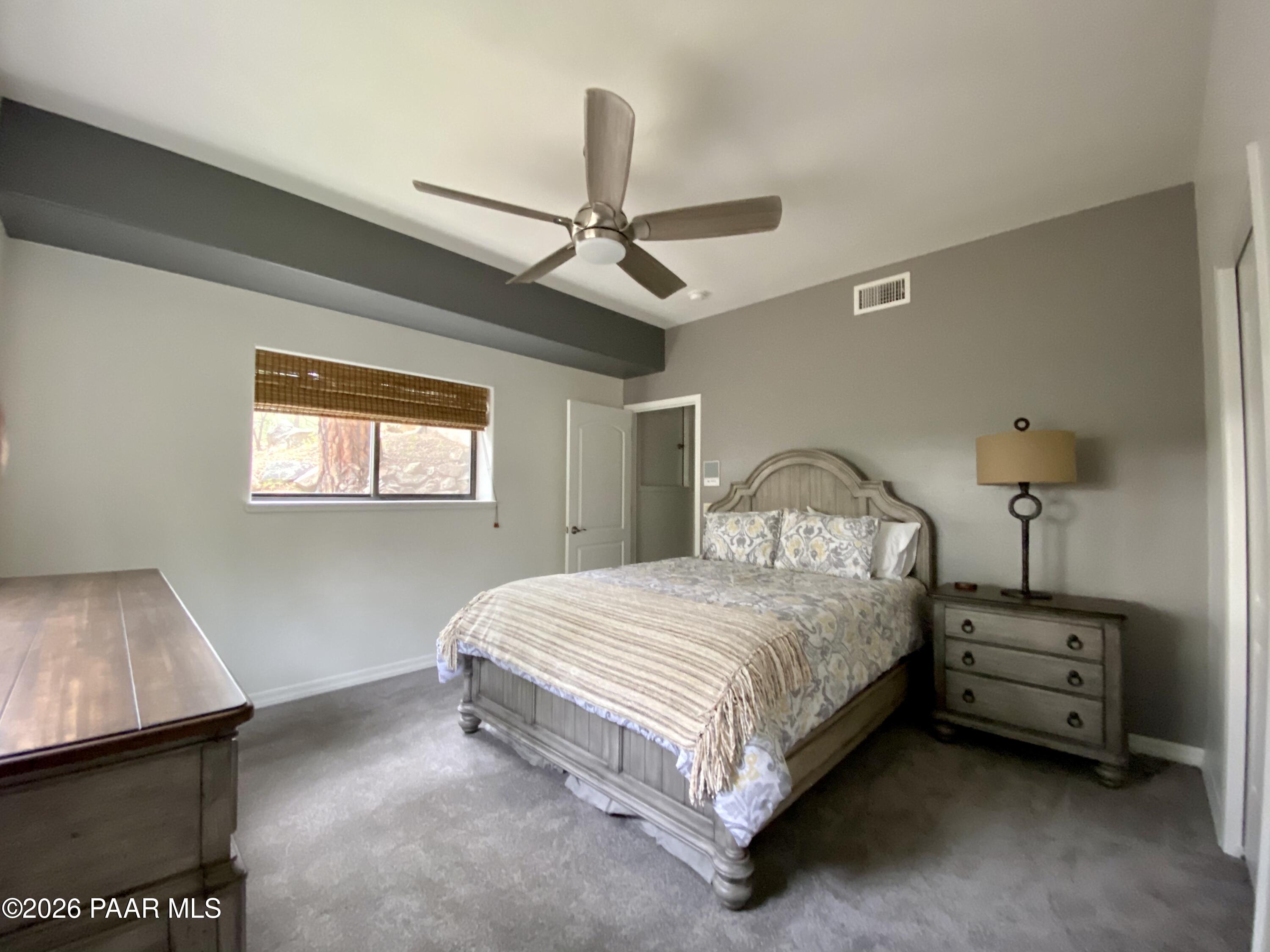 1677 Coyote Road Prescott, AZ 86303 - Photo 12 of 24 a bedroom with a bed dresser and a window