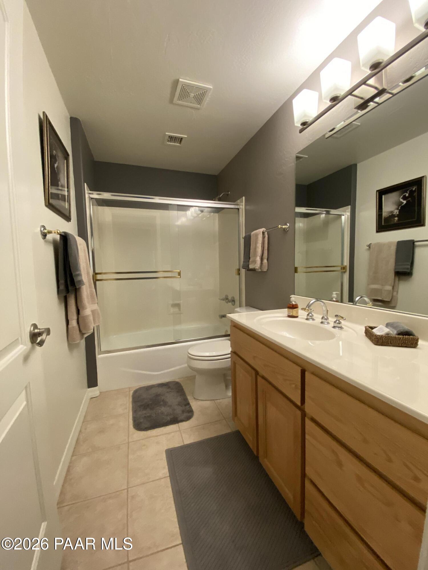 1677 Coyote Road Prescott, AZ 86303 - Photo 15 of 24 a bathroom with a sink a toilet and shower