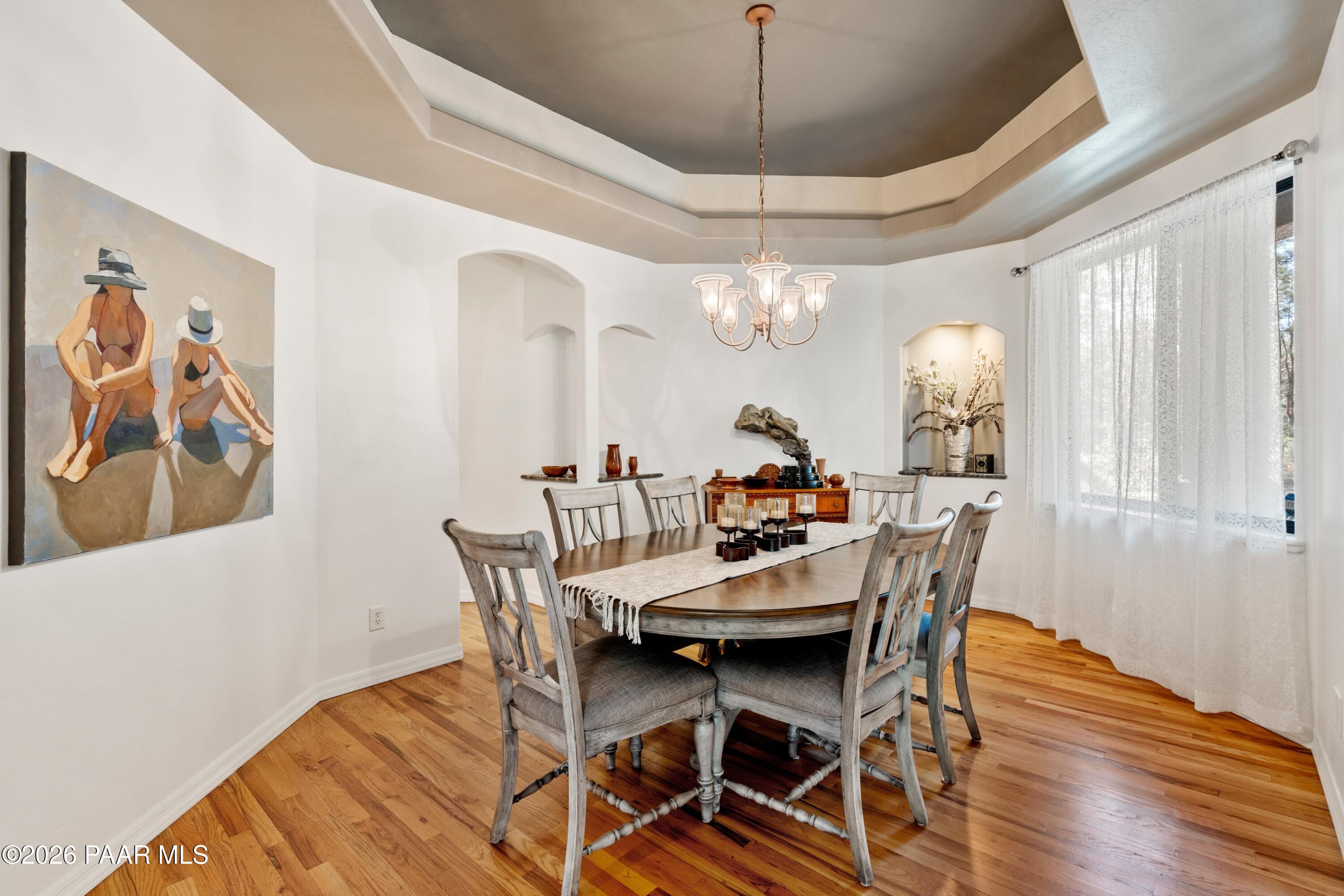 1677 Coyote Road Prescott, AZ 86303 - Photo 8 of 24 a view of a dining room with furniture a chandelier and wooden floor