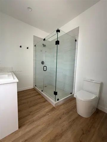 a bathroom with a shower and toilet